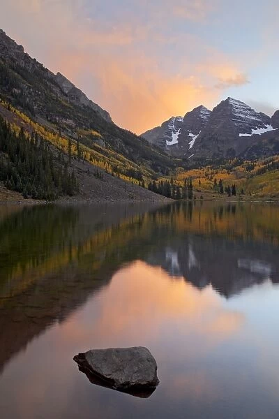 Maroon Bells with fall colors during a clearing storm in the evening, White River National Forest