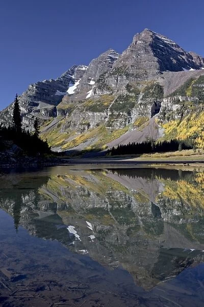 Maroon Bells reflected in Crater Lake with fall color, White River National Forest