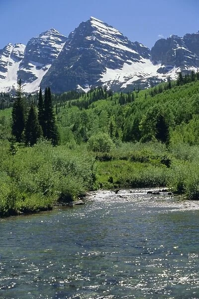 Maroon Bells seen from stream rushing to feed Maroon Lake nearby