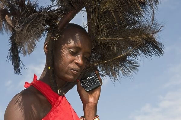 Masai man talking on mobile phone, Masai Mara, Kenya, East Africa, Africa