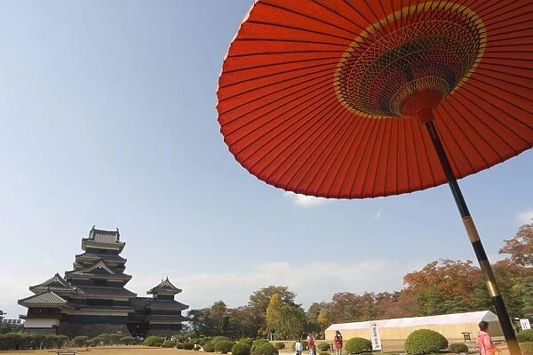Matsumoto Castle under red parasol