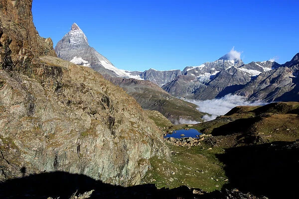 Matterhorn and Dent Blanche and the blue waters of Lake Riffelsee, Zermatt, Canton of Valais