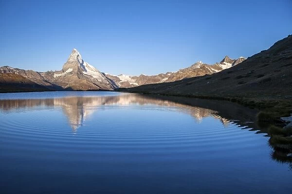 The Matterhorn reflected in Stellisee at sunrise, Zermatt, Canton of Valais, Pennine Alps