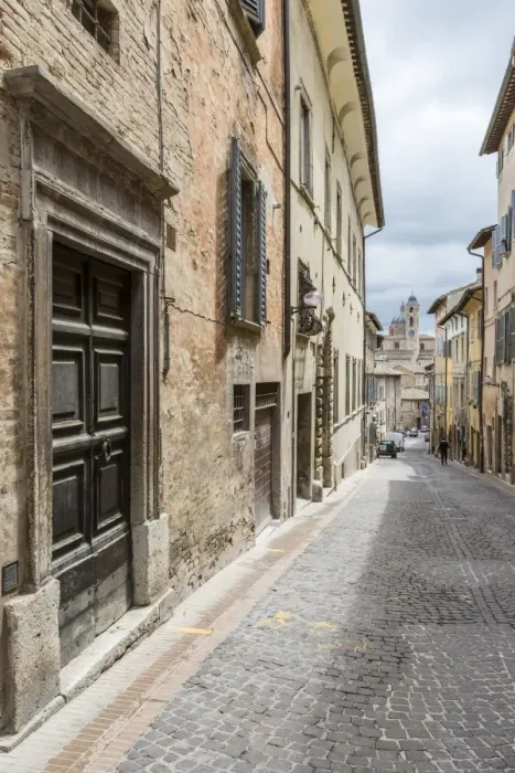Framed Print : A medieval alley of the hill town with Piazza Duca Federico in the background, Urbino Framed Print : A medieval alley of the hill town with Piazza Duca Federico in the background, Urbino
