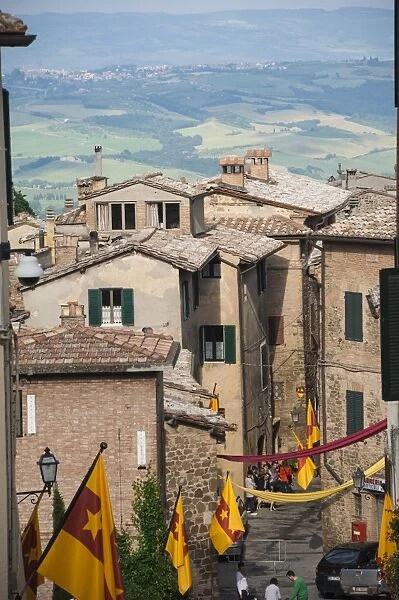 Medieval street decorated with local area flags, Montalcino, UNESCO World Heritage Site, Val d Orcia, Tuscany, Italy, Europe