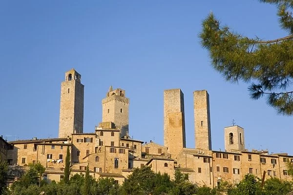 Medieval towers lit by the rising sun, San Gimignano, UNESCO World Heritage Site, Siena, Tuscany, Italy, Europe
