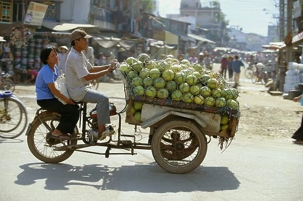 Melons being transported on three wheeler Xe Lam in downtown area