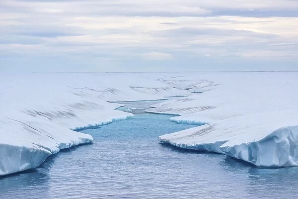 Melt water stream in tabular iceberg in Isabella Bay, Baffin Island, Nunavut, Canada, North America