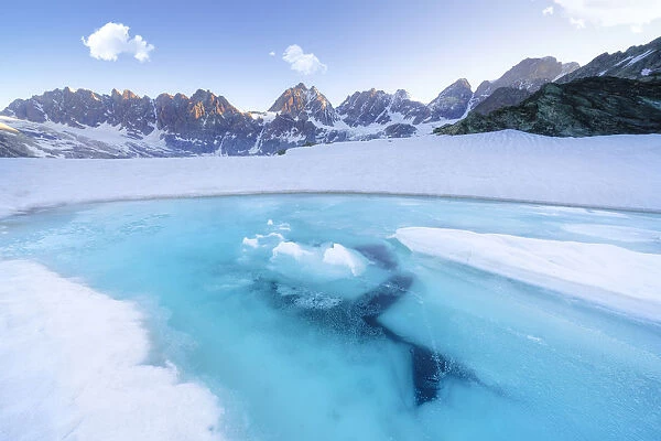 Melting ice on surface of Forbici Lake during spring thaw, Valmalenco, Valtellina