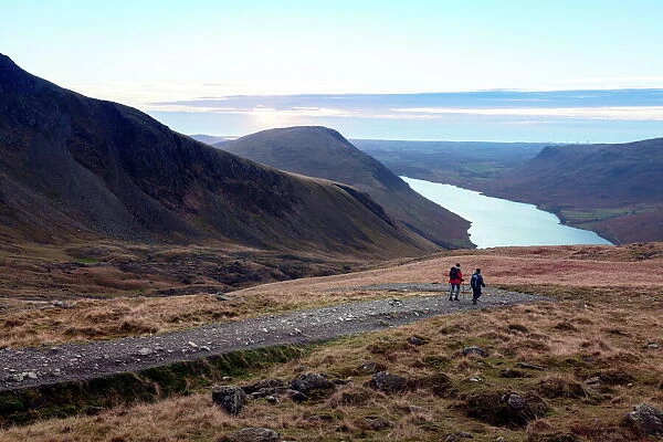Two men descend from Scafell Pike towards Wast Water, Lake District, Cumbria, England