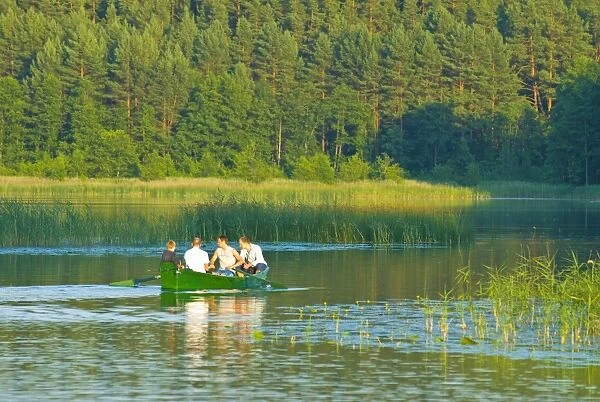 Men in a rowing boat at the Aukstaitija National Park, Lithuania, Baltic States, Europe