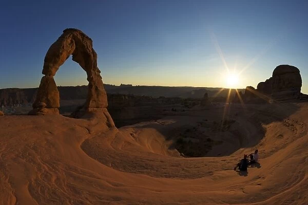 Two men sitting, Delicate Arch, Arches National Park, Moab, Utah, United States of America, North America