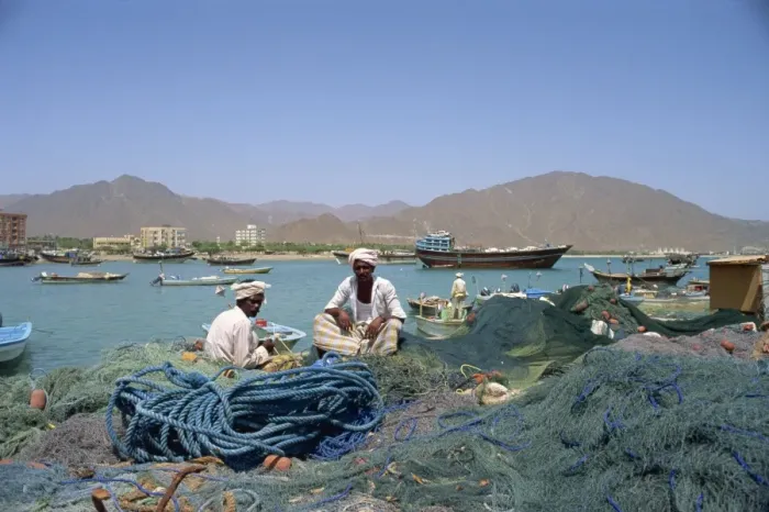 Framed Print : Men sitting amongst fishing nets at dockside Framed Print : Men sitting amongst fishing nets at dockside