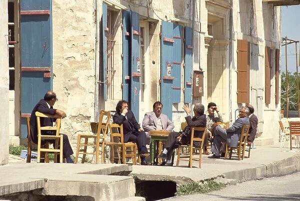 Men sitting outside on the pavement, putting the world to rights, one Sunday morning in Lefkara