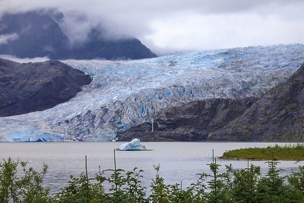 Mendenhall Glacier and Lake, with iceberg, bright blue ice, forest and mist, from Visitor Centre