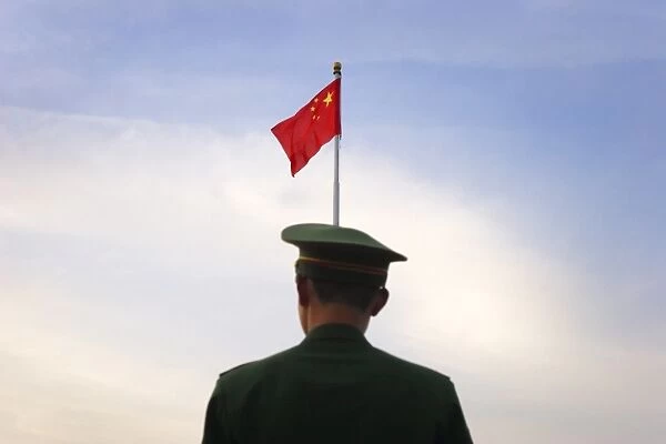 Military police prepare to lower the national flag in Tiananmen Square