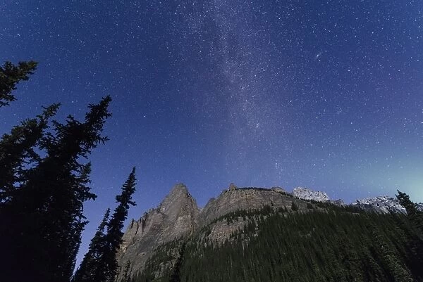 Milky way rises over the Canadian Rockies in the Yoho National Park, with moonlight