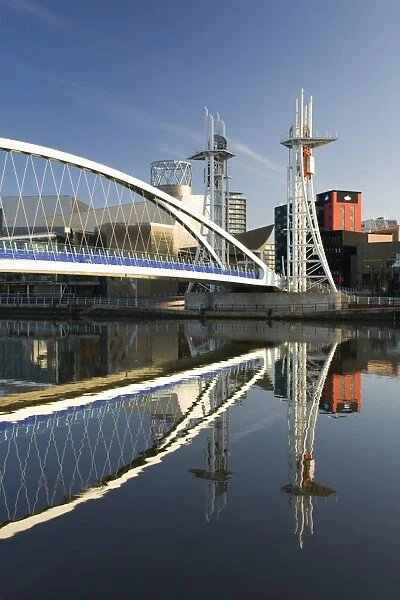 The Millennium Bridge reflected in the Manchester Ship Canal, Salford Quays, Salford, Greater Manchester, England, United Kingdom, Europe