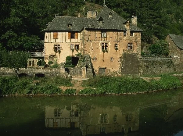 A millhouse reflected in water, near Conques, Aveyron, Midi-Pyrenees, France, Europe