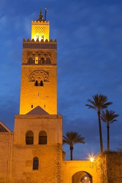 The Minaret of the Koutoubia Mosque illuminated at dusk with palm trees, UNESCO World Heritage Site, Marrakech, Morocco, North Africa, Africa