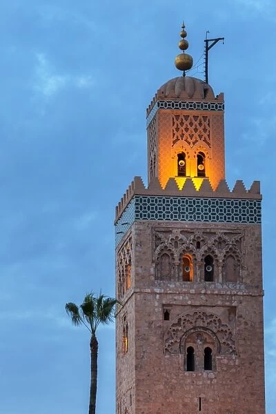 The Minaret of the Koutoubia Mosque, illuminated at dusk with single palm tree, UNESCO World Heritage Site, Marrakech, Morocco, North Africa, Africa