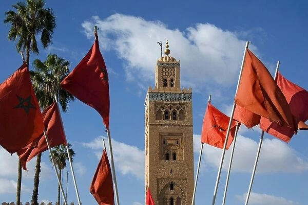 Minaret of the Koutoubia Mosque, UNESCO World Heritage Site, and Moroccan flags