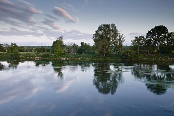 An almost mirror reflection in the River Cher near Villefranche-sur-Cher, Centre, France, Europe