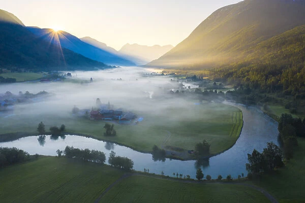 Mist over the cultivated fields along Stryneelva river, aerial view, Stryn, Nordfjorden