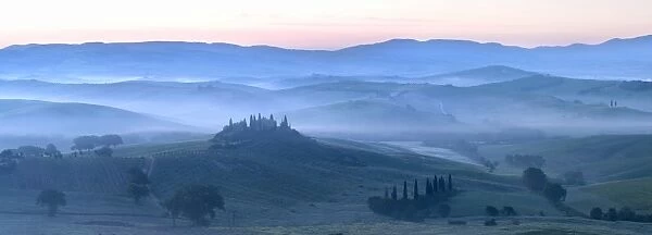 Misty dawn panoramic view towards Belvedere, across Val d Orcia, UNESCO World Heritage Site