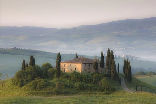 Misty dawn view towards Belvedere across Val d Orcia, UNESCO World Heritage Site