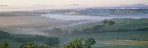 Misty dawn view across Val d Orcia towards the Belvedere