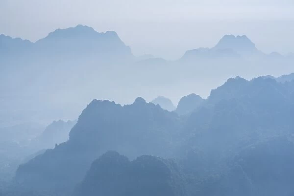 Misty limestone karst mountain landscape at sunrise, seen from Mount Zwegabin, Hpa An