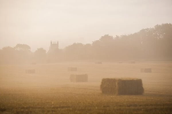 Misty sunrise at St. James Church at Longborough, a village in The Cotswolds, Gloucestershire, England, United Kingdom, Europe