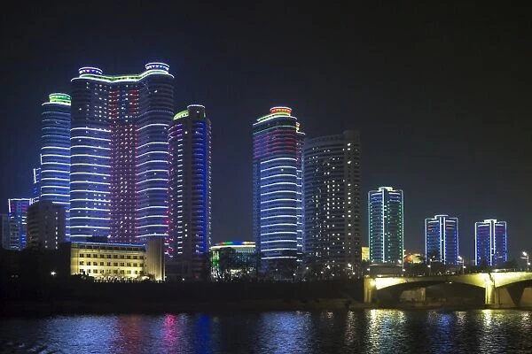 Modern city apartments illuminated at night, Pyongyang, Democratic Peoples Republic of Korea (DPRK), North Korea, Asia