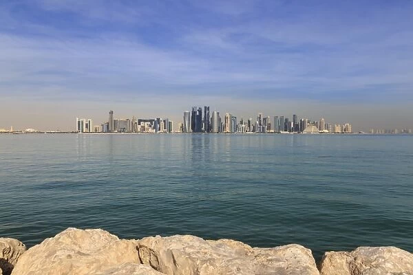 Modern city skyline of West Bay, across the calm turquoise waters of Doha Bay
