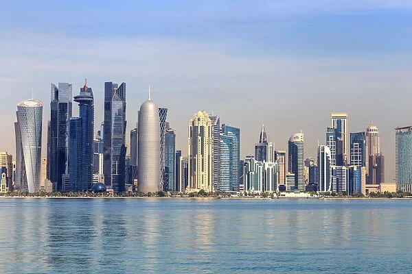 Modern city skyline of West Bay, across the calm waters of Doha Bay, from the Dhow Harbour