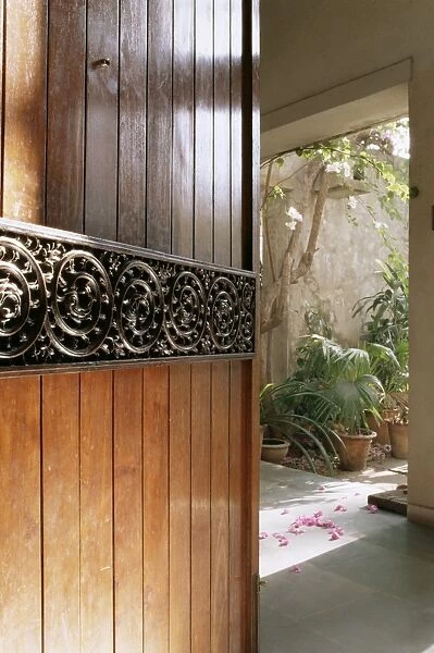 A modern front door decorated with a 400 year old piece