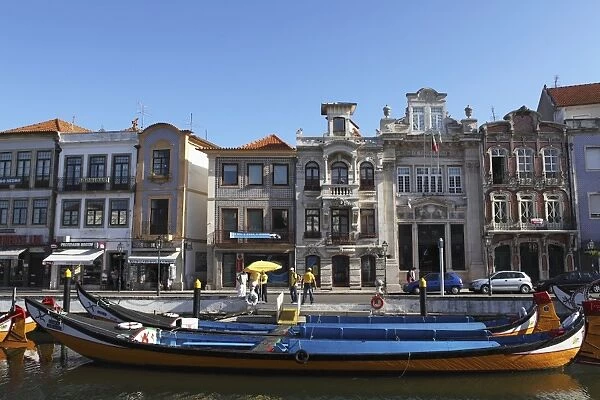 Moliceiro boats docked by Art Nouveau style buildings along the Central Canal