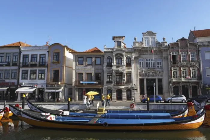 Framed Print : Moliceiro boats docked by Art Nouveau style buildings along the Central Canal Framed Print : Moliceiro boats docked by Art Nouveau style buildings along the Central Canal