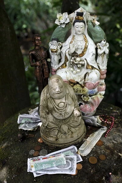 Money offering and statues in the garden of Buddhapadipa temple, Wimbledon, London
