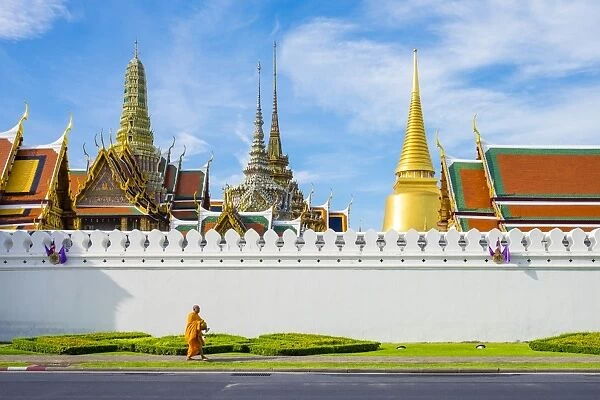 A monk passes in front of Wat Phra Kaew and the Grand Palace, Bangkok, Thailand, Southeast Asia
