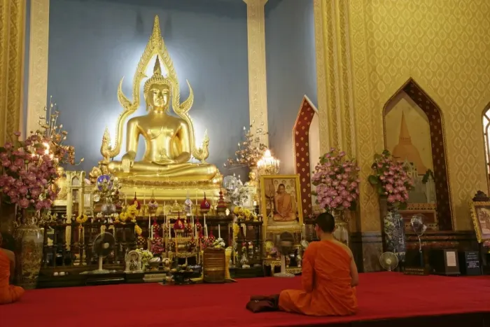 Framed Print : Monk praying and giant golden statue of the Buddha Framed Print : Monk praying and giant golden statue of the Buddha