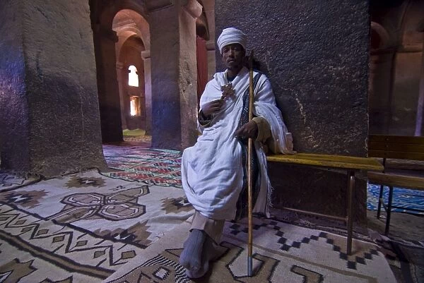 Monk sitting in the rock carved monastery of Lalibela, Northern Ethiopia, Africa