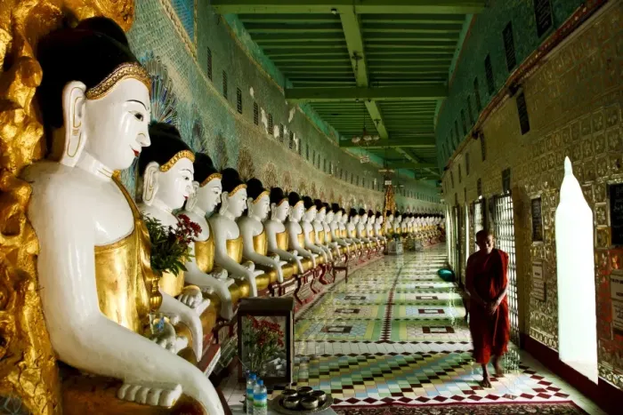 Framed Print : Monk walking past Buddha statues in a crescent shaped colonnade in Umin Thounzeh Framed Print : Monk walking past Buddha statues in a crescent shaped colonnade in Umin Thounzeh