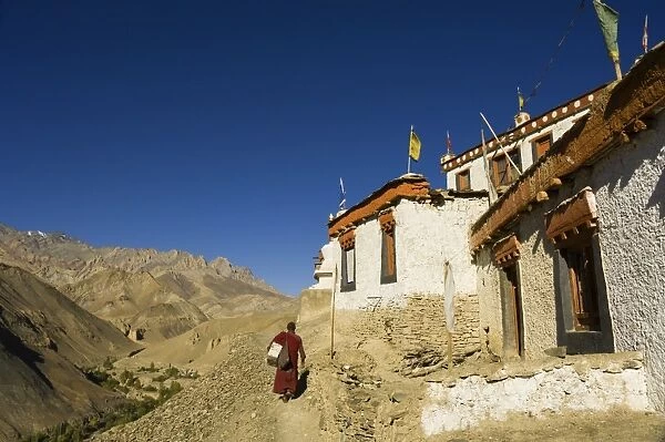 Monk walking past Lamayuru gompa (monastery)