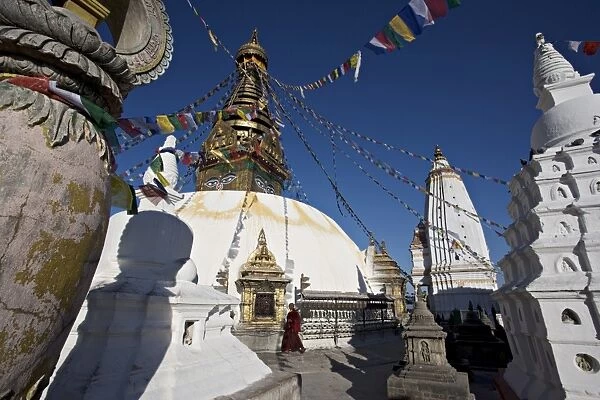 A monk walks clockwise around the buddhist stupa called