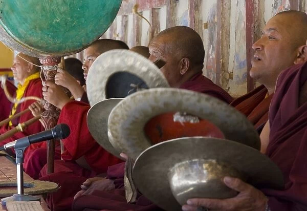 Monks accompanying those dancing with traditional drums