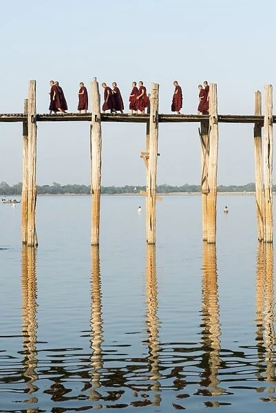 Monks crossing the U Bien bridge across Taungthaman Lake, Amarapura, Mandalay, Myanmar (Burma)