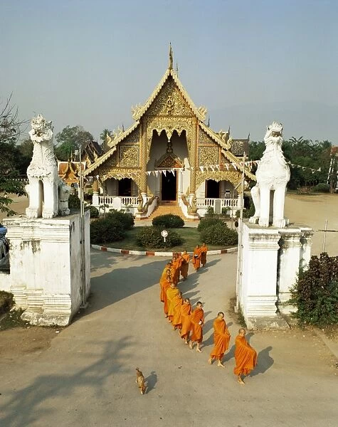 Monks leaving Wat Phra Singh to collect alms