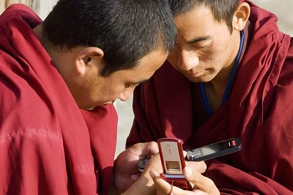 Monks with mobile phones, Xiahe monastery, Xiahe, Gansu, China, Asia